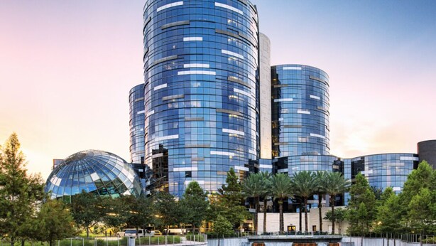 A modern building with a cylindrical design, featuring reflective glass windows and a central dome structure. - Sweet Magnolia, 3Br/2.5Ba, Downtown Historic Charm w/ all the comforts!  (Orlando)