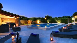 A pool area with lounge chairs and a pergola, surrounded by a landscaped garden. - H2904 Finca Creva with pool for 10 people in Pollenca (Pollenca)