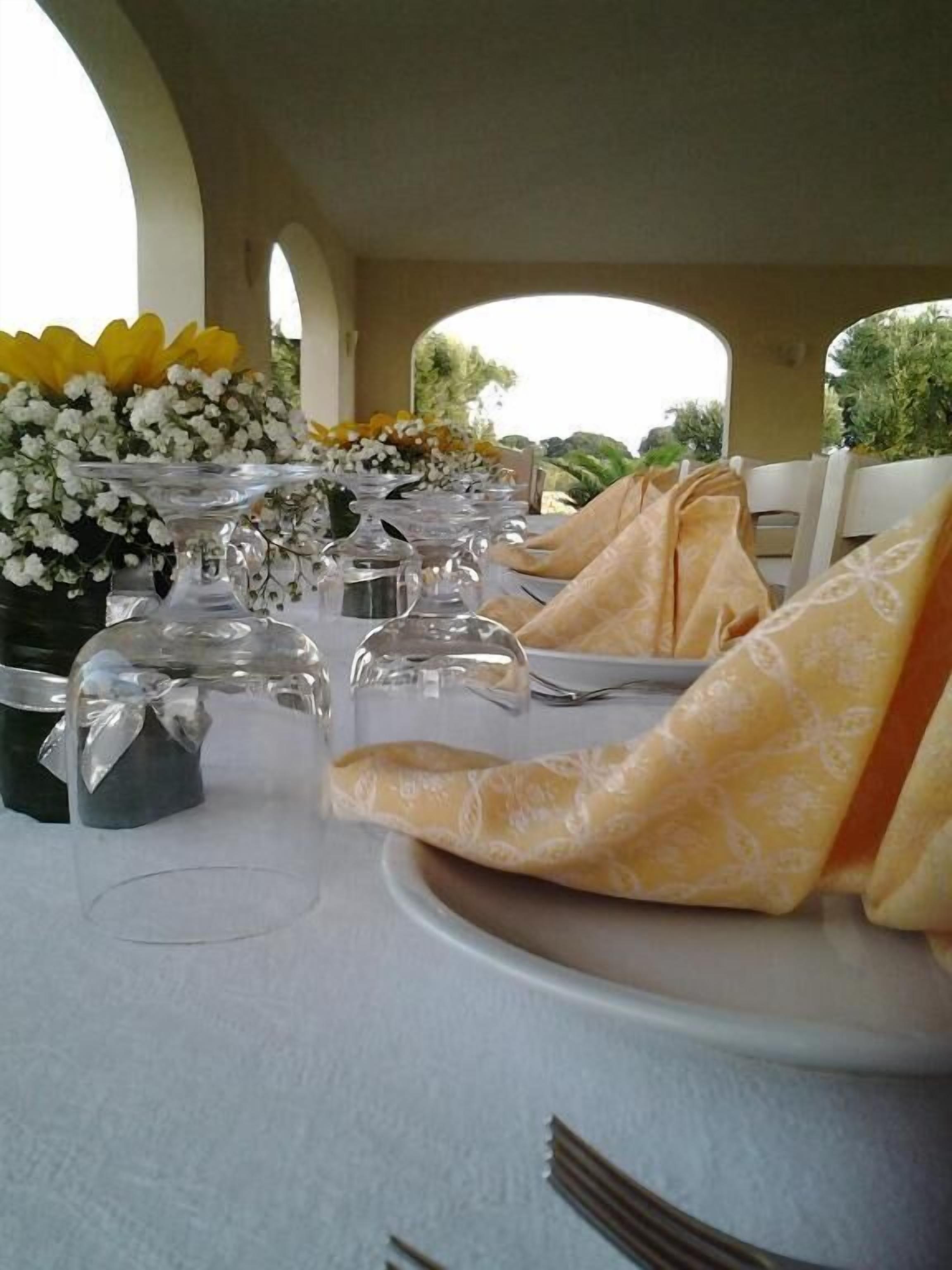 A table set for a formal event with clear glassware and folded napkins.