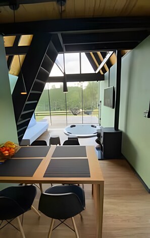 A modern interior with a dining area, a hot tub, and a view of the outdoors. - Sitio Sunset Joy (Santa Maria)