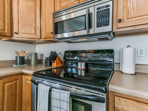 Fridge, coffee/tea maker, cookware/dishes/utensils