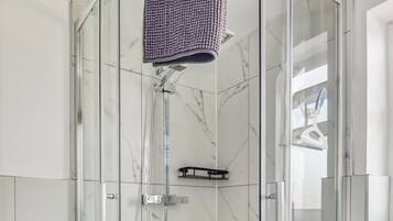 Shower, rainfall showerhead, towels, toilet paper
