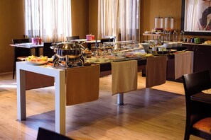 A buffet setup with various food items and a coffee station. - Hotel FortyFive (Chivasso)