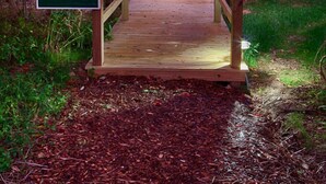 A wooden bridge leading to a red tent-like structure labeled "Firefly."