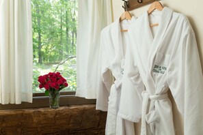 Relax in style with a bathtub and enjoy the serene view of the lush forest through the window.