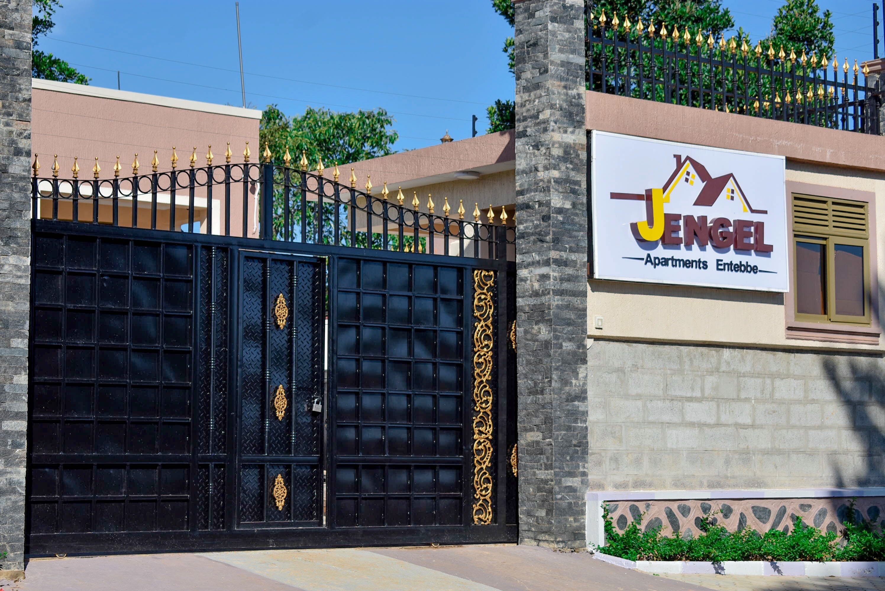A gated entrance with a sign for Jengel Apartments.