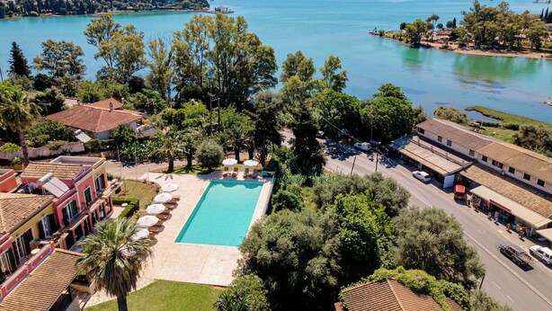 A resort with a swimming pool, a road, and a view of a lake. - Ionian Arches Corfu (Corfu)