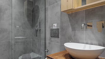 Bathtub, hair dryer, towels, toilet paper