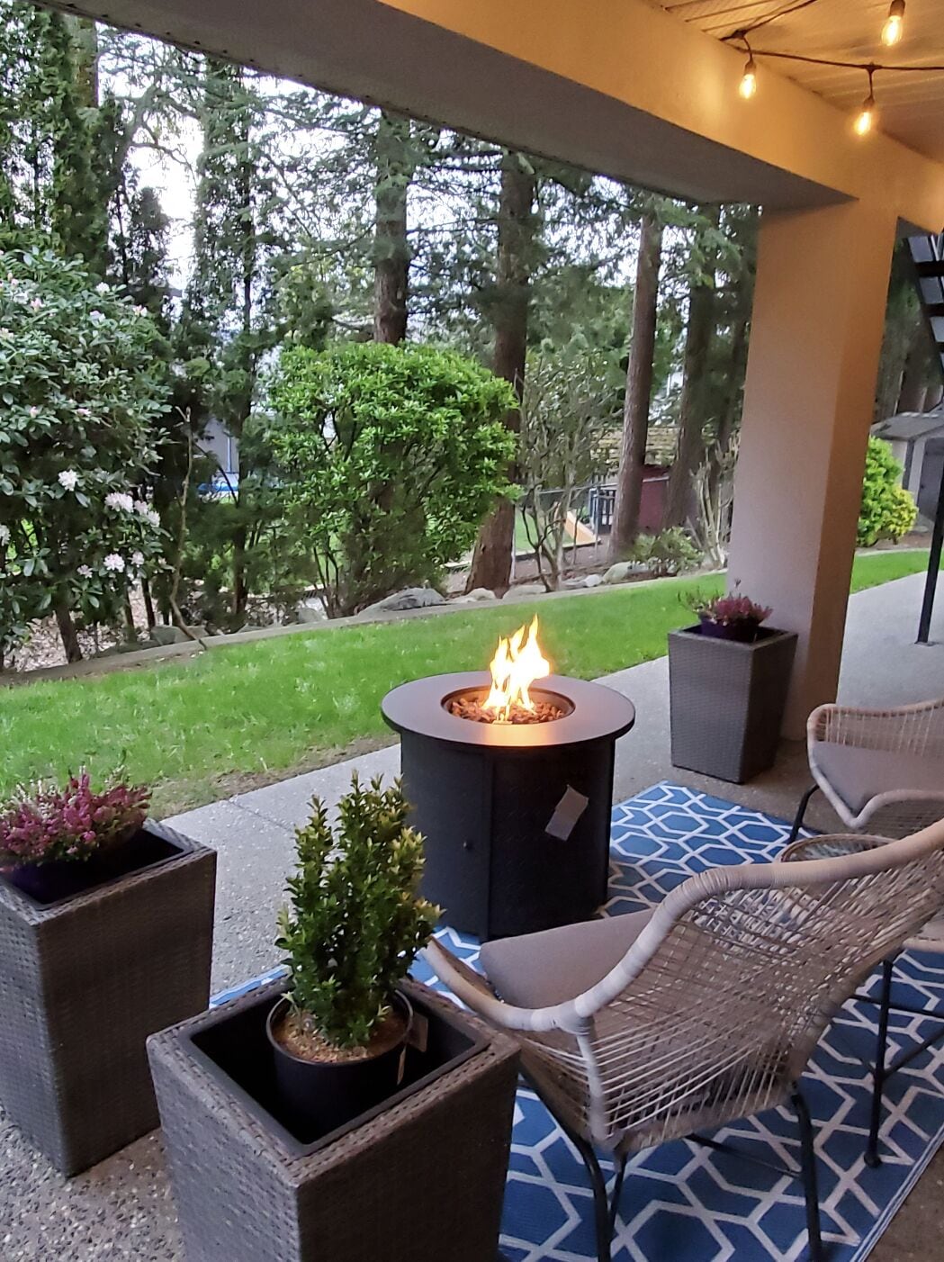 Covered non-smoking patio with fire table and garden view