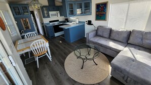 A compact living space with a kitchenette, a dining area, and a seating area.