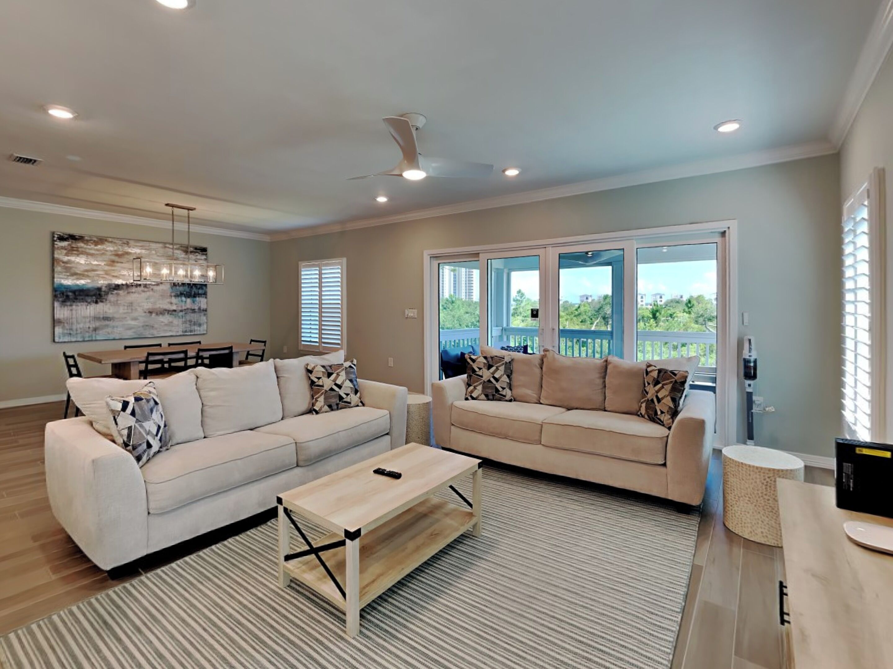 A spacious living room with two sofas, a coffee table, and a dining area.