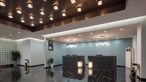 A modern reception area with a marble floor, a reception desk, and a ceiling with recessed lighting. - Days Inn by Wyndham Yangzhou Guangling (Yangzhou)