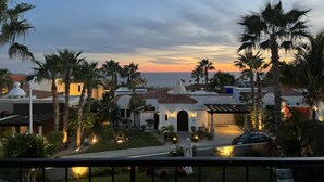 A coastal property with a view of the sea at sunset, featuring palm trees, a well-maintained lawn, and traditional architecture. - Christmas or NYE in CABO!
Private Pool with Ocean View!
Entire Villa all for YOU (Cabo San Lucas)