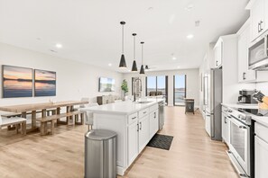 Enjoy cooking and dining in this well-lit kitchen with a central island, oven, and microwave.
