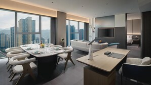 A modern living room with a large dining table, a sofa, and a TV. - Crowne Plaza Shangluo (Shanglou)