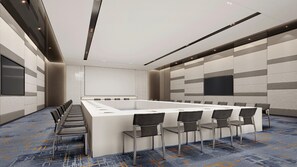 A conference room with a long table, chairs, a whiteboard, and a carpeted floor. - Crowne Plaza Shangluo (Shanglou)