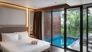 A hotel room with a large bed, a nightstand, a window with a view of a swimming pool and greenery. - Morickap Lord's 83, Trademark Collection by Wyndham (Sulthan Bathery)
