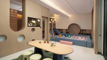 A children's play area with a table, chairs, toys, and a slide.