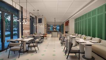 A modern restaurant with a long dining area, large windows, and green shutters on the right wall.