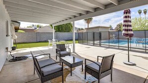A covered patio with outdoor furniture, a pool, and a view of the backyard. - Cozy on Cactus, Phoenix Escape! Private Pool Oasis, Pet-Friendly, Near Top Attractions! (Phoenix)