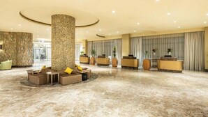 A spacious lobby with a central column, seating areas, reception desks, and a marble floor. - Copthorne Makkah Al Naseem (Makkah)
