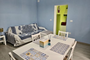 A room with a bed, a table with a box and incense sticks, and a chair. - SE045 - Senigallia, three-room apartment convenient to services (Senigallia)