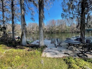 A lakeside park with a wooden dock, benches, and a picnic table. - 3 Story Rainbow Riverfront House With Panoramic Views!  (Dunnellon)