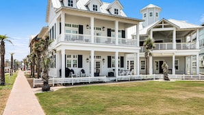 A large, two-story building with a covered porch and multiple balconies. - Park Place 251 LAU (Port Aransas)