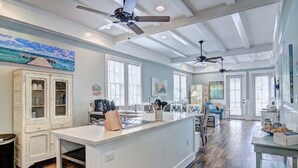 A spacious kitchen with a large island, white cabinetry, and a ceiling fan. - Suntide TC 1103 (Port Aransas)