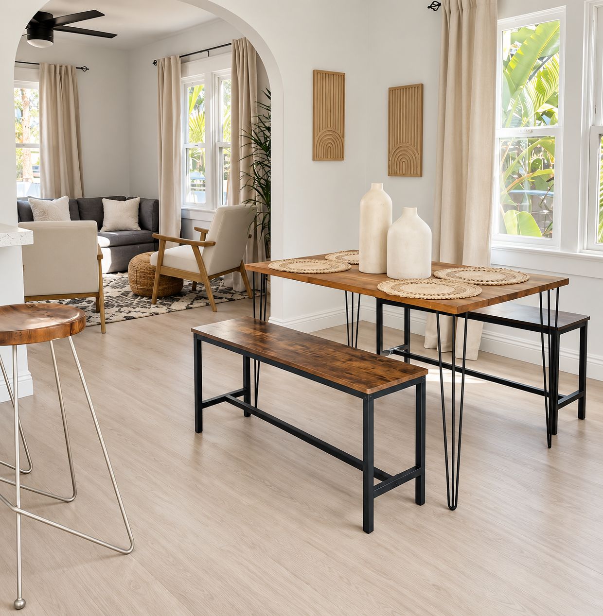 A modern living room with a wooden dining table, a sofa, and a coffee table.