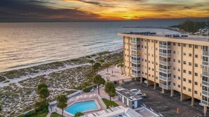A hotel with a pool, beach view, and a sunset. - San Marco 5th Floor With Private Beach (Venice)