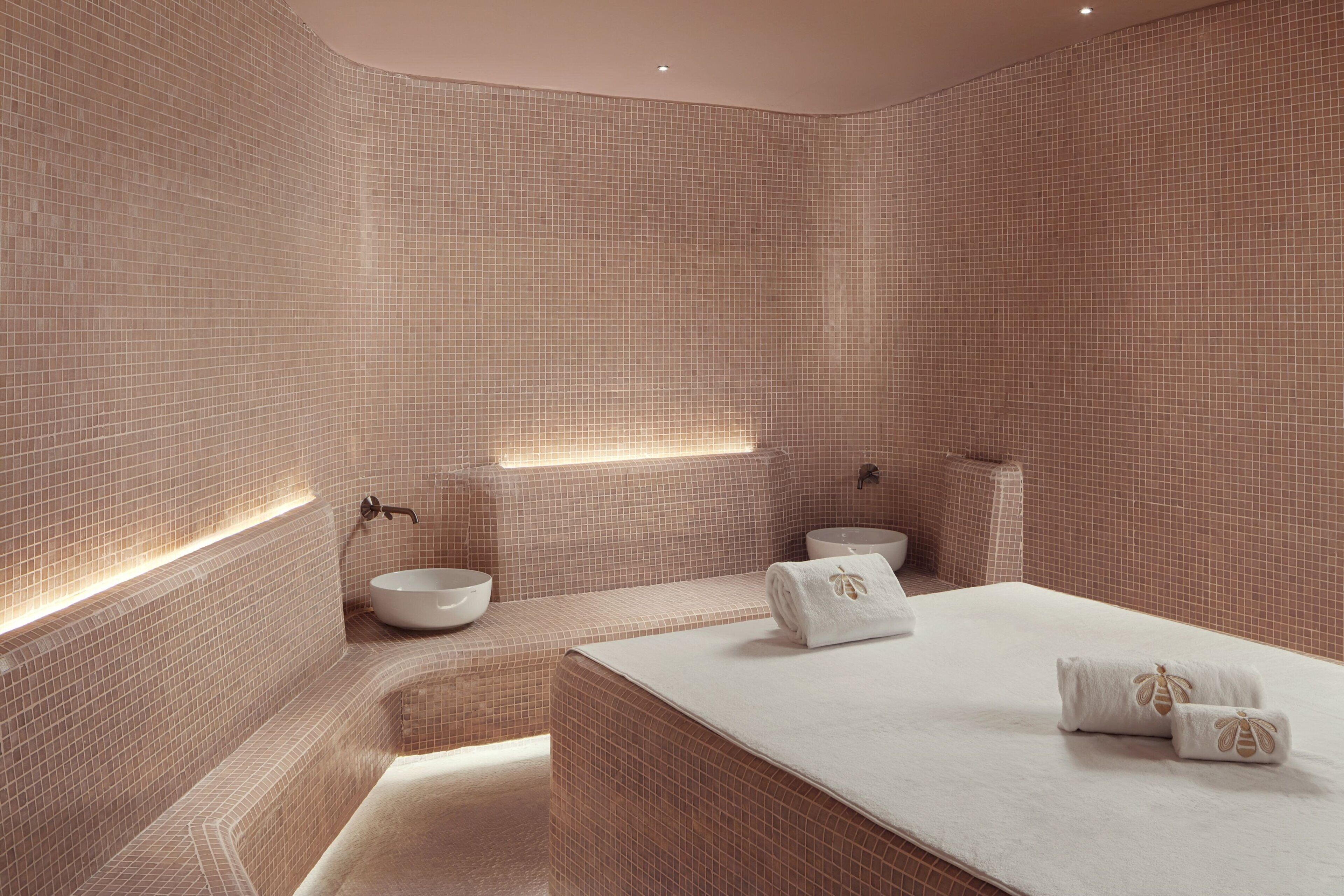 A modern bathroom with a large bathtub, a sink, and a toilet.