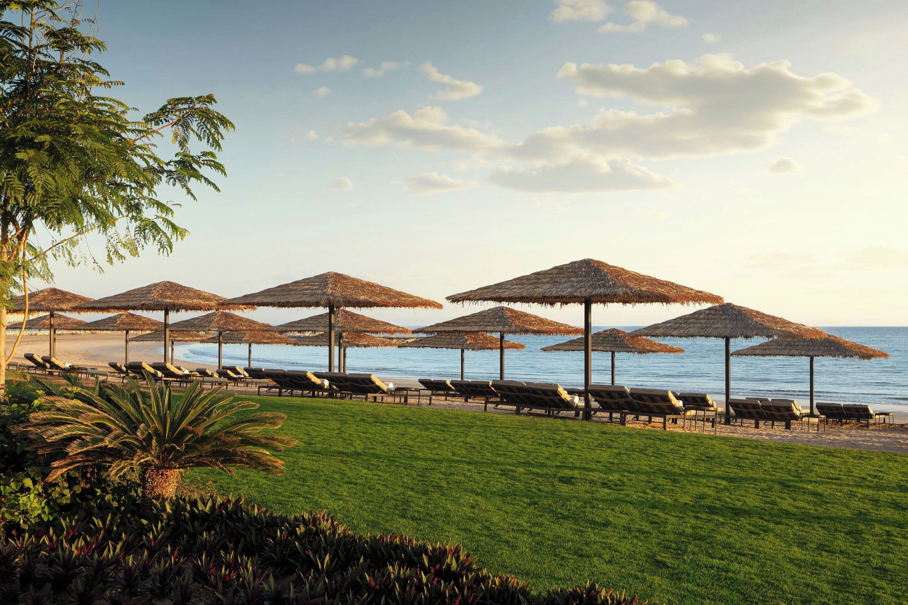 On the beach, white sand, sun loungers, beach umbrellas