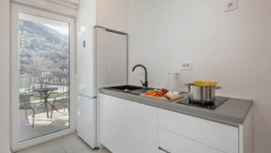 A modern kitchen with a built-in stove, a sink, and a refrigerator. - Sea-View Balcony Apt Lady Laura, Plomin, Croatia (Plomin)
