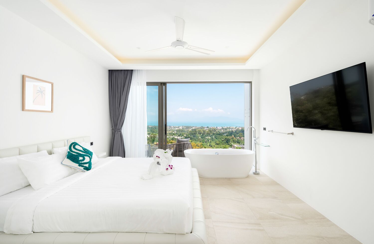 A modern hotel room with a large bed, a bathtub, a flat-screen TV, and a city view.