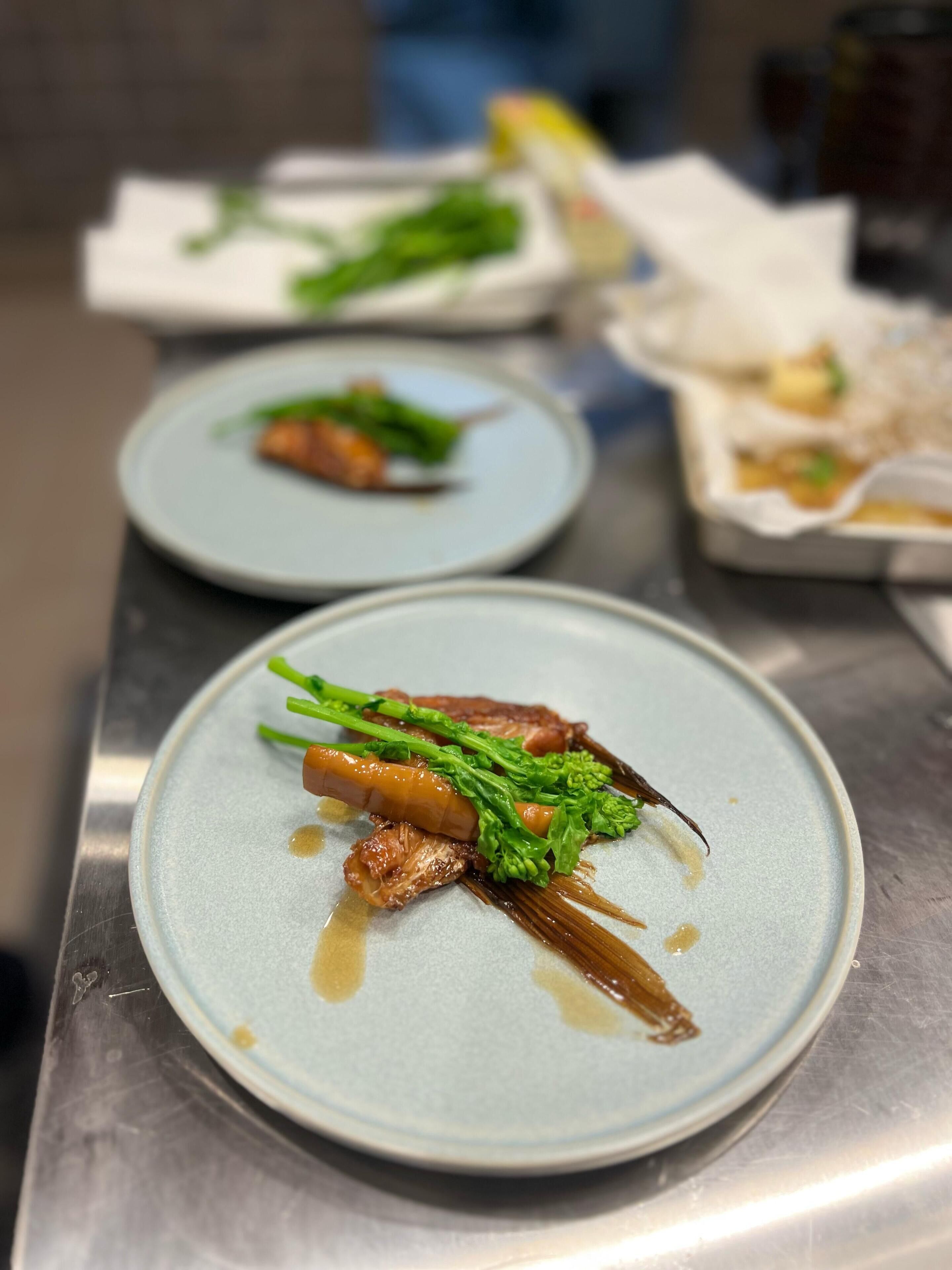 A series of plates with food, arranged on a metallic surface.