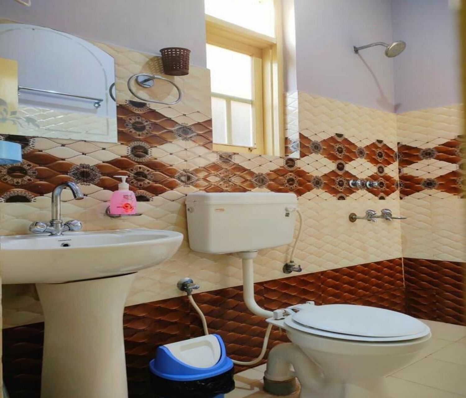 A bathroom with a sink, toilet, and shower.