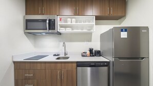 A compact kitchen with a microwave, coffee maker, and refrigerator. - MainStay Suites Chambersburg (Chambersburg)