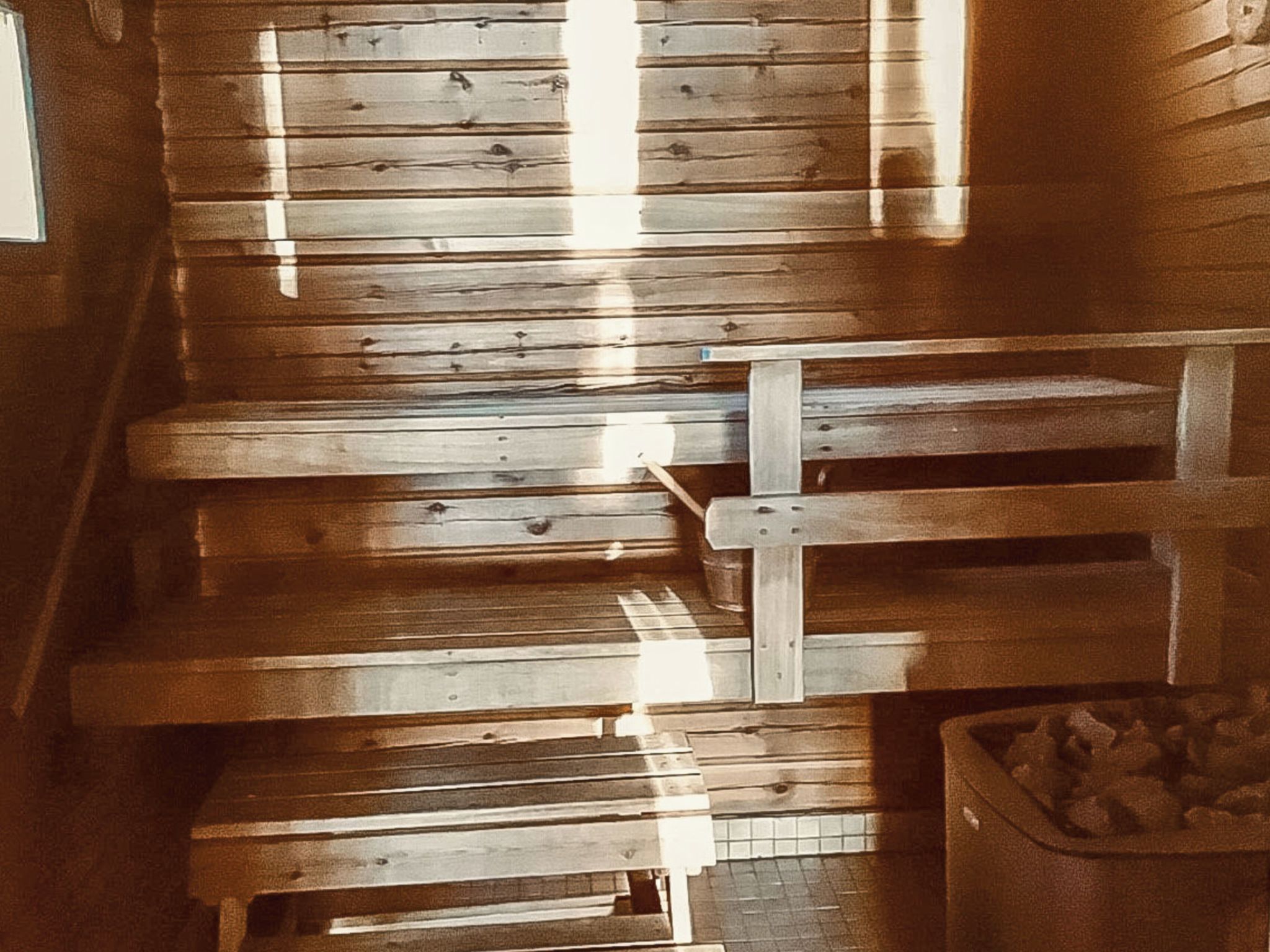 A wooden staircase with a trash bin at the bottom.