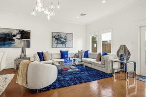 A modern living room with a sofa, coffee table, and decorative items.