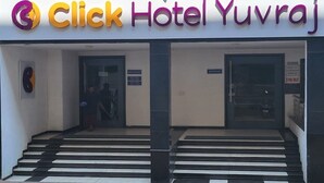 The entrance to Click Hotel Yuvraj with a staircase leading up to the reception area. - Click Hotel Yuvraj (Surat)
