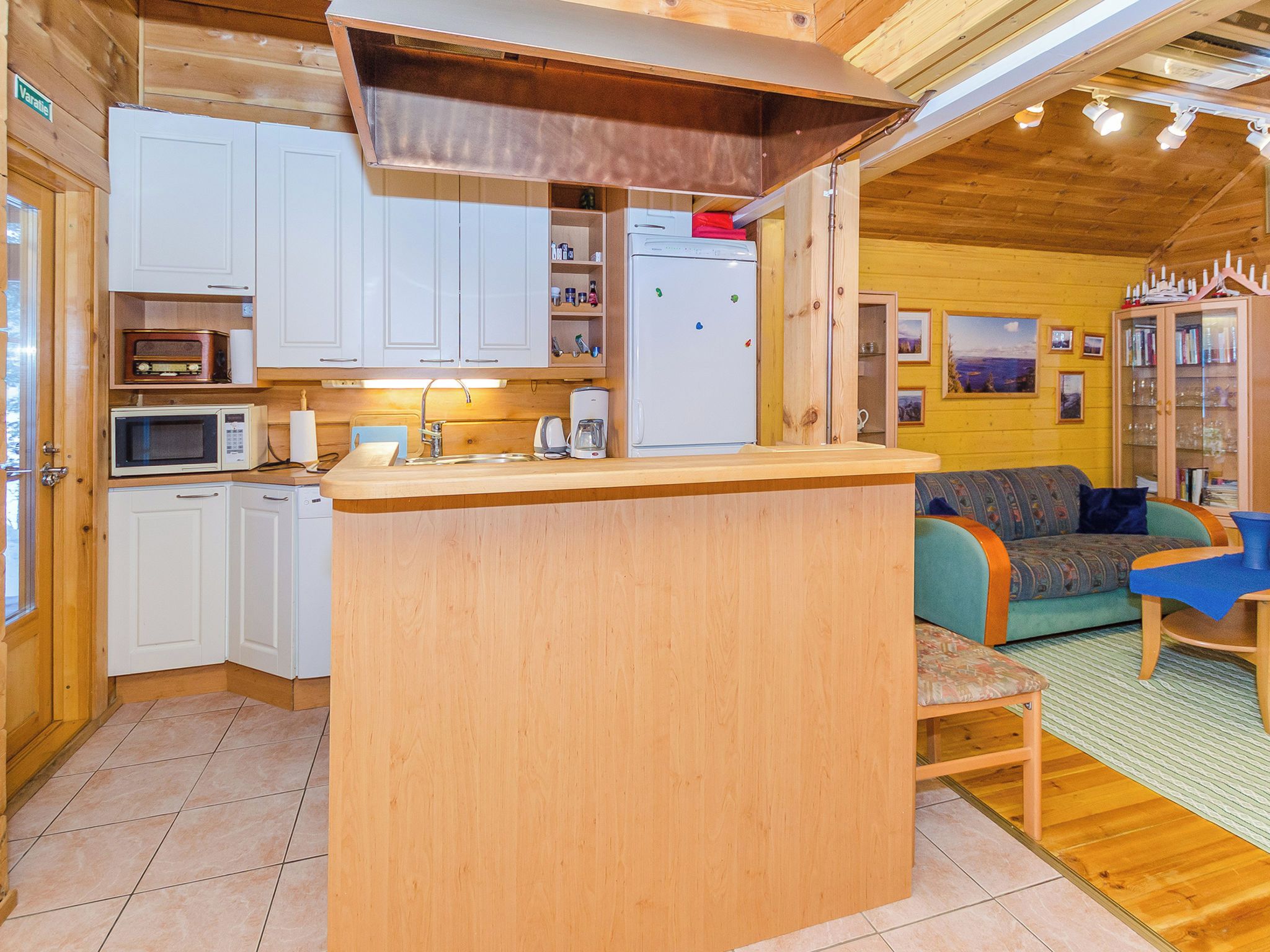 A compact kitchen with white cabinets, a microwave, and a refrigerator.