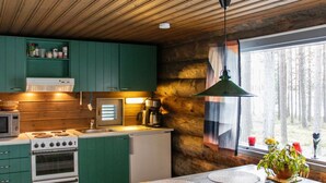 A modern kitchen with wooden cabinets, a stove, and a coffee maker.