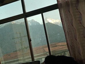Enjoy breathtaking views of the surrounding mountains from this room's expansive window.