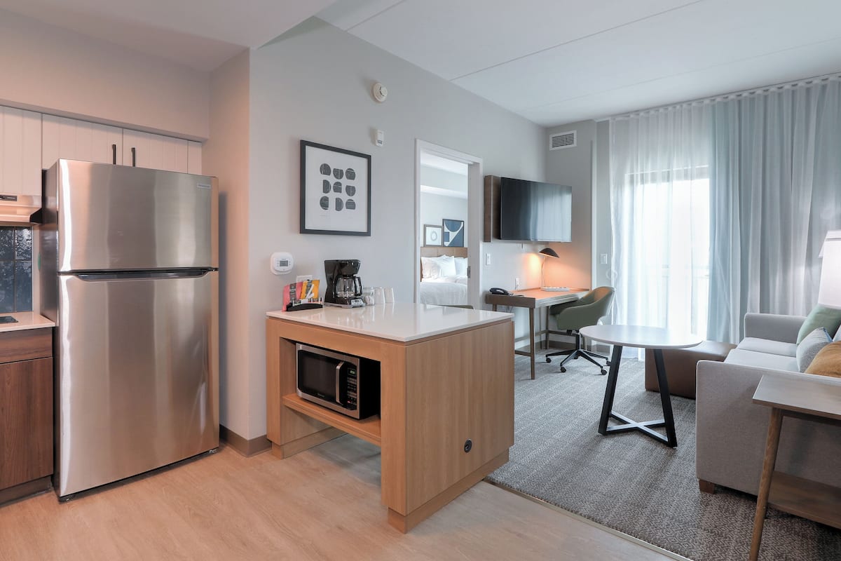 Hypo-allergenic bedding, desk, laptop workspace, blackout drapes