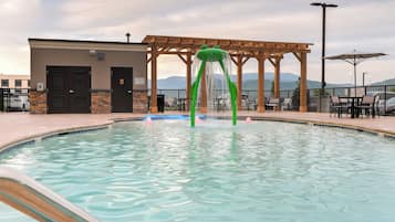 Outdoor pool, open 7:00 AM to 10:00 PM, pool umbrellas