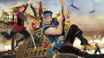 A pirate-themed scene with a ship, ropes, and characters in costumes.