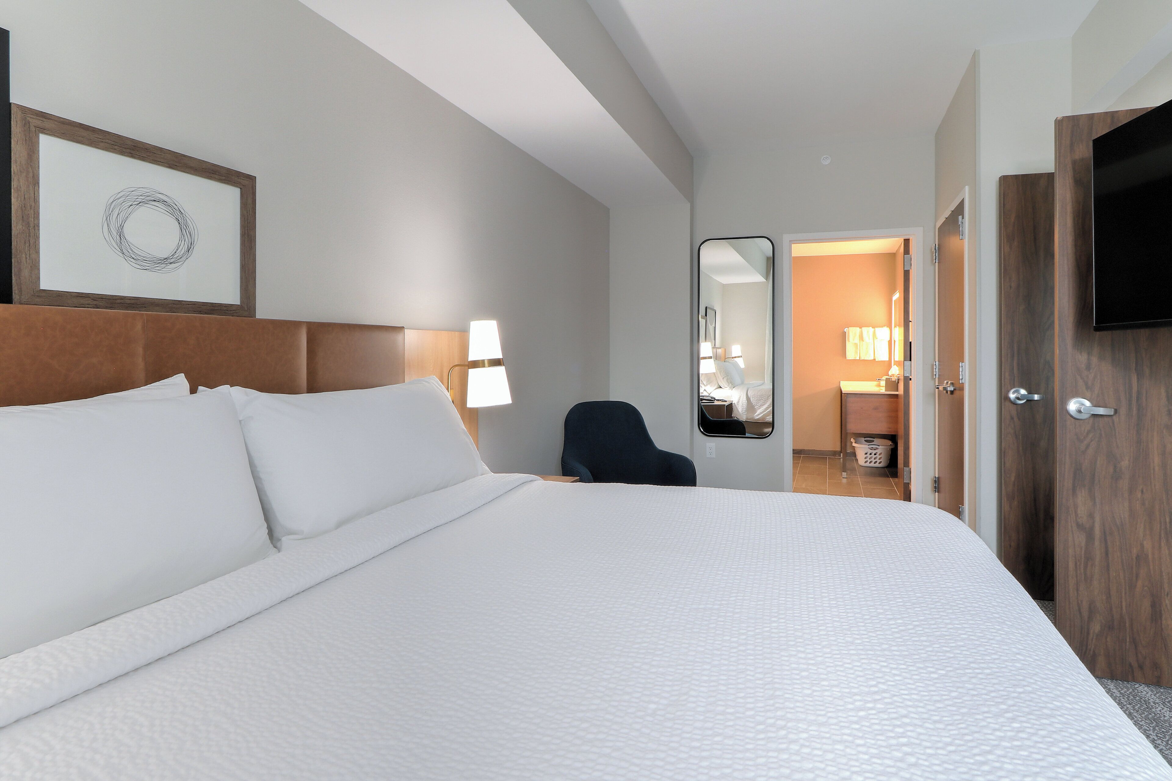 Hypo-allergenic bedding, desk, laptop workspace, blackout drapes