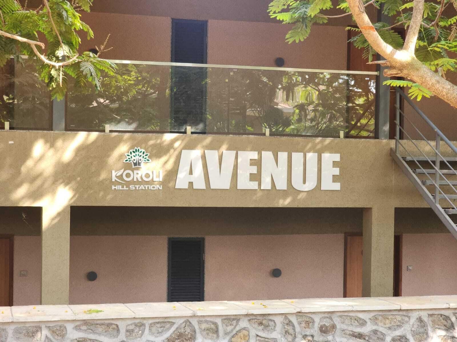 A building with a sign reading "AVENUE" and "KOROLI HILL STATION".
