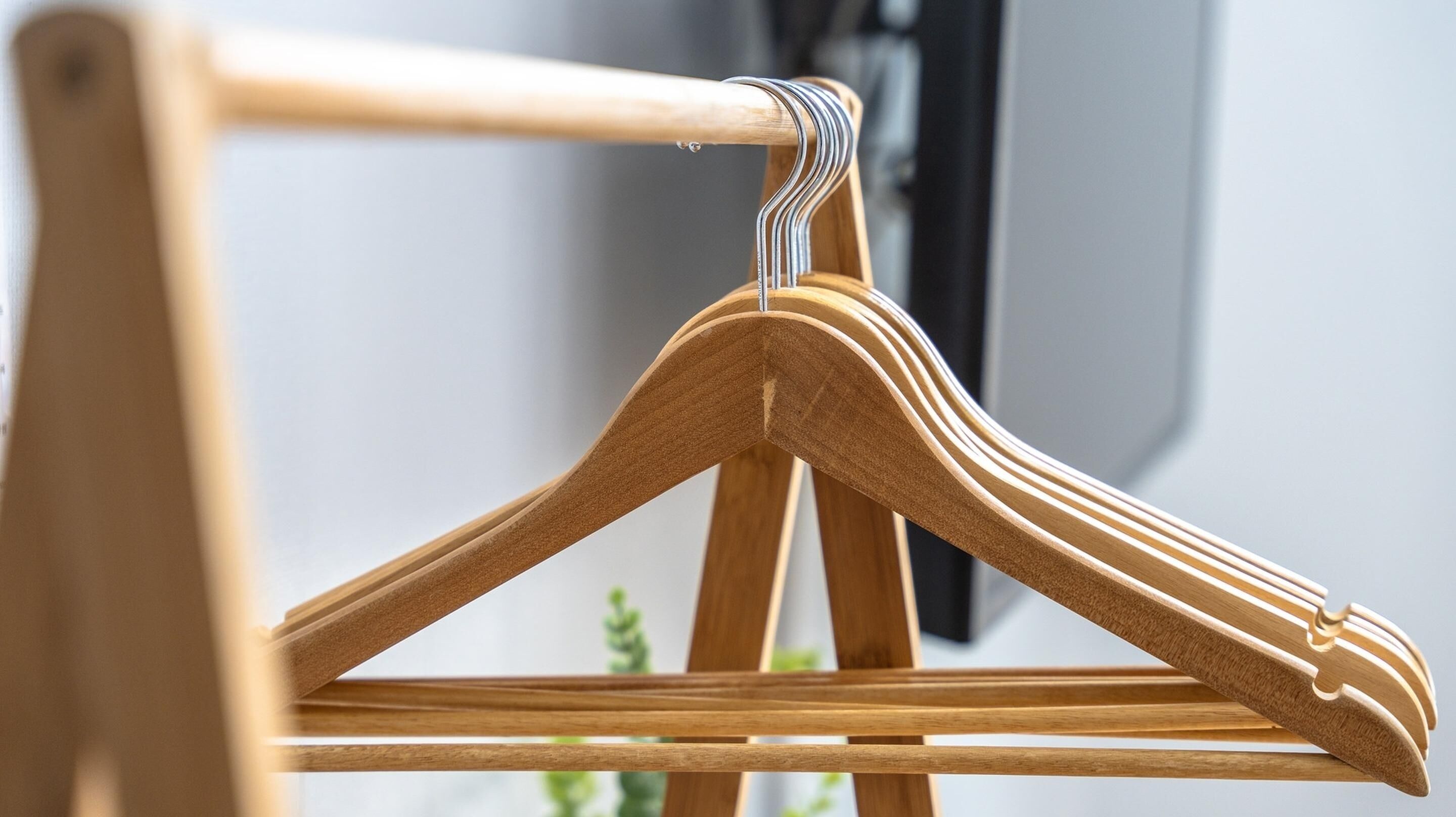 A wooden hanger with a metal hook.